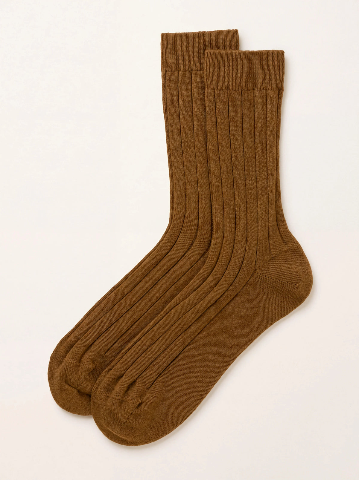Dark camel ribbed cashmere socks laid flat, showing the vertical rib knit with smooth toe and heel