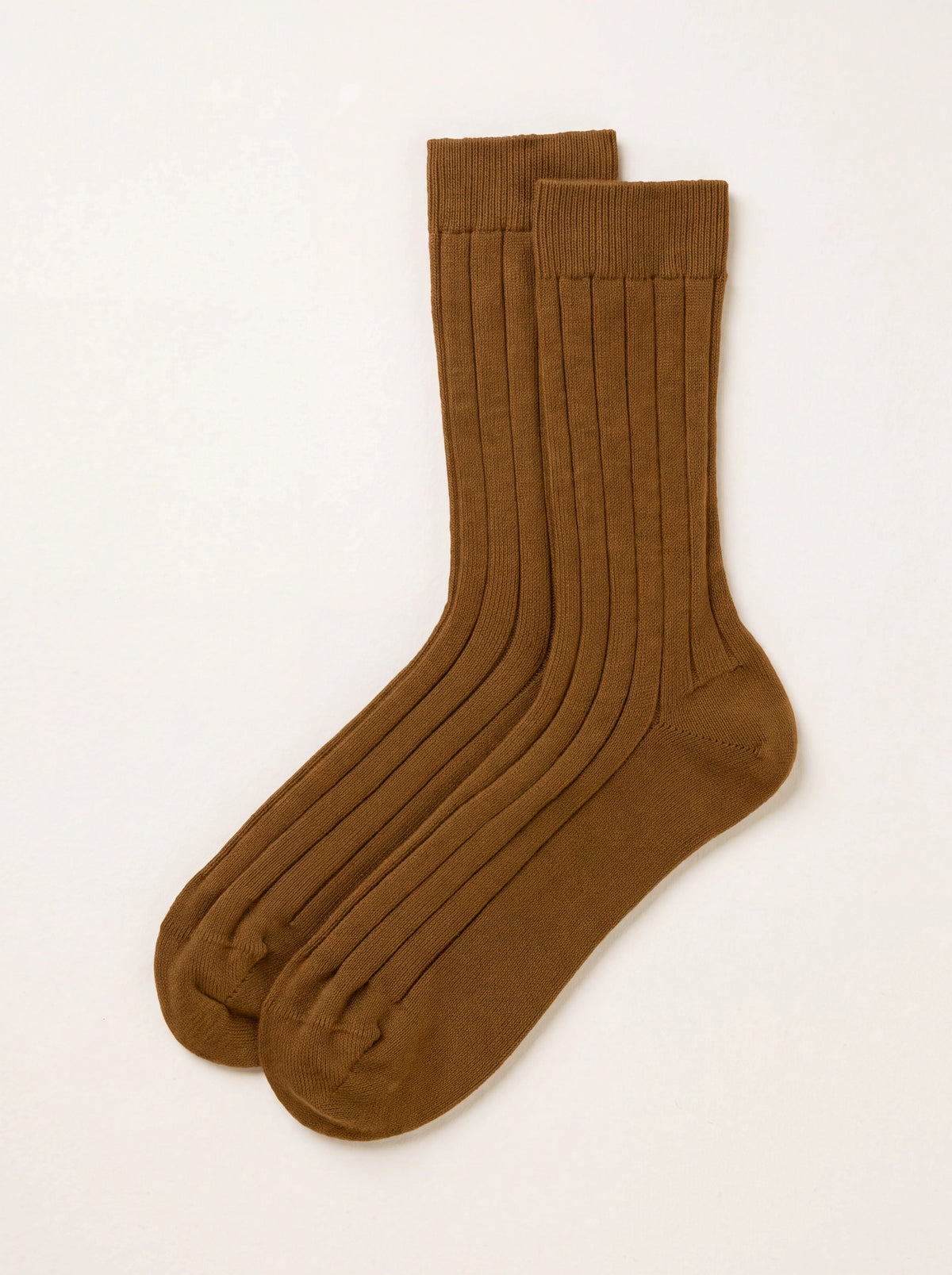 Dark camel ribbed cashmere socks laid flat, featuring wide vertical ribs and smooth heel and toe