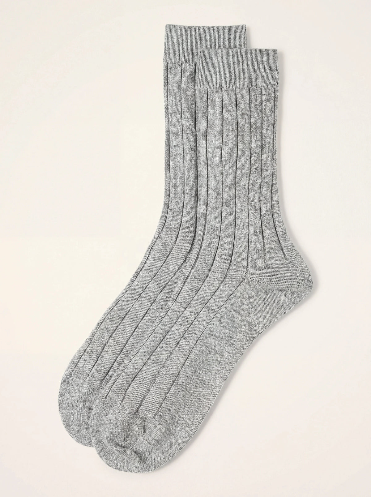 Pair of light grey ribbed cashmere socks laid flat, showing the rib texture and cuffs
