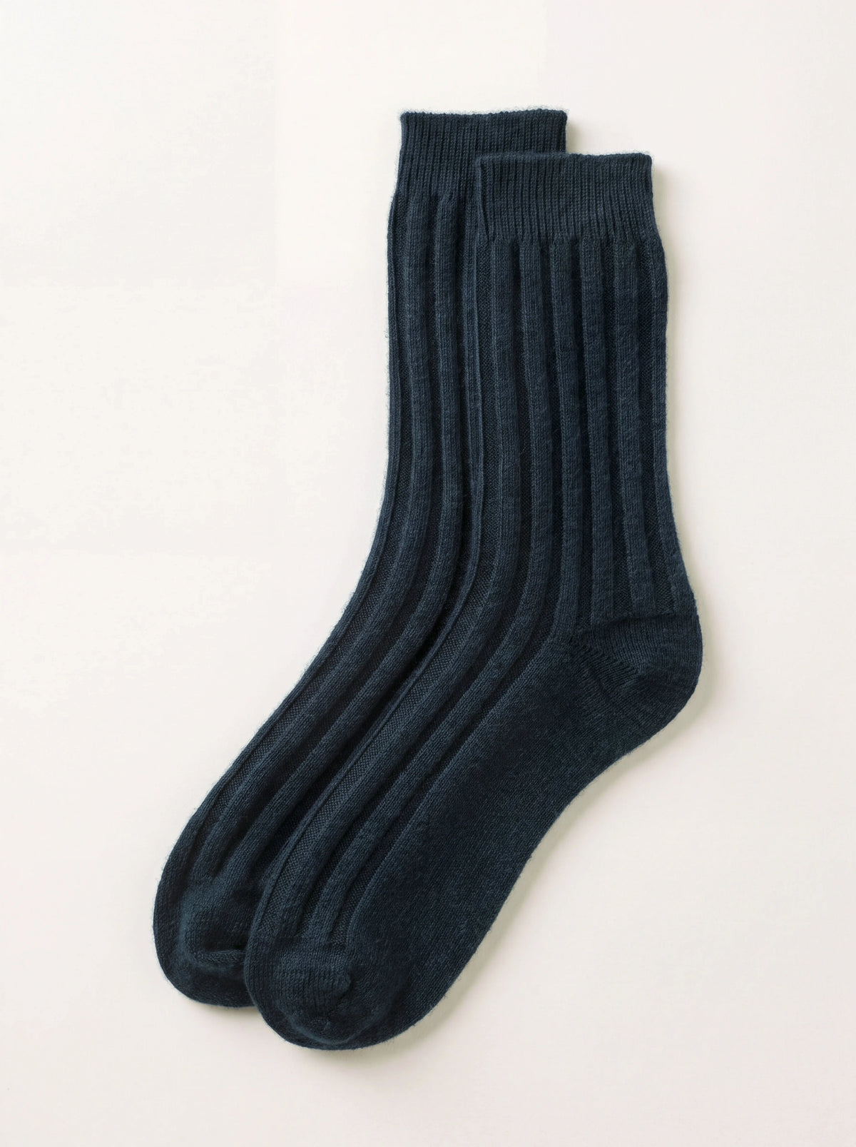 Pair of bottle green ribbed cashmere travel socks laid flat
