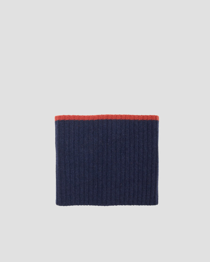 Navy blue ribbed merino wool tubular scarf laid flat with a contrasting rust-red trim