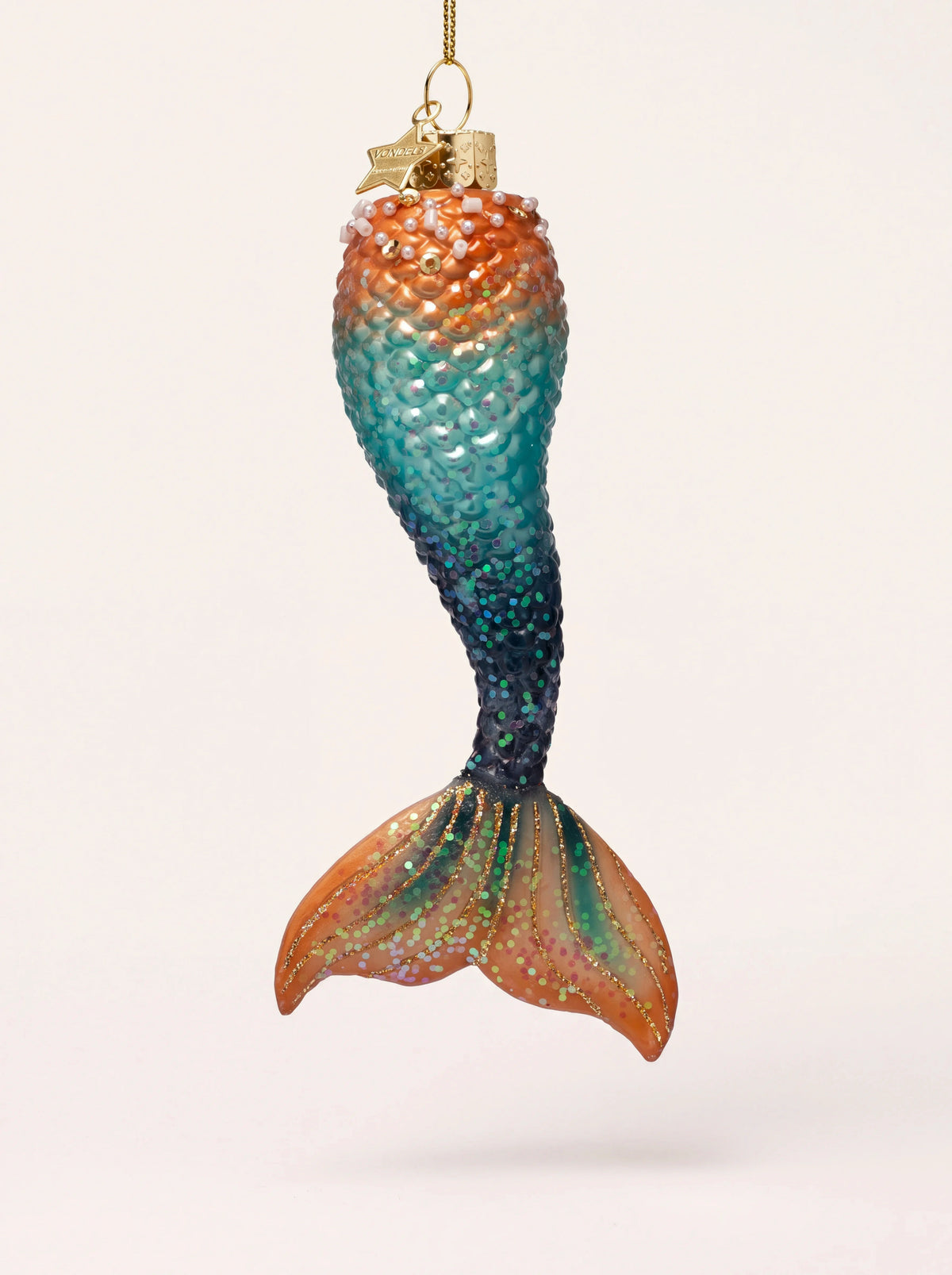 Glass mermaid tail ornament in an orange and blue gradient with textured scales and glitter detailing