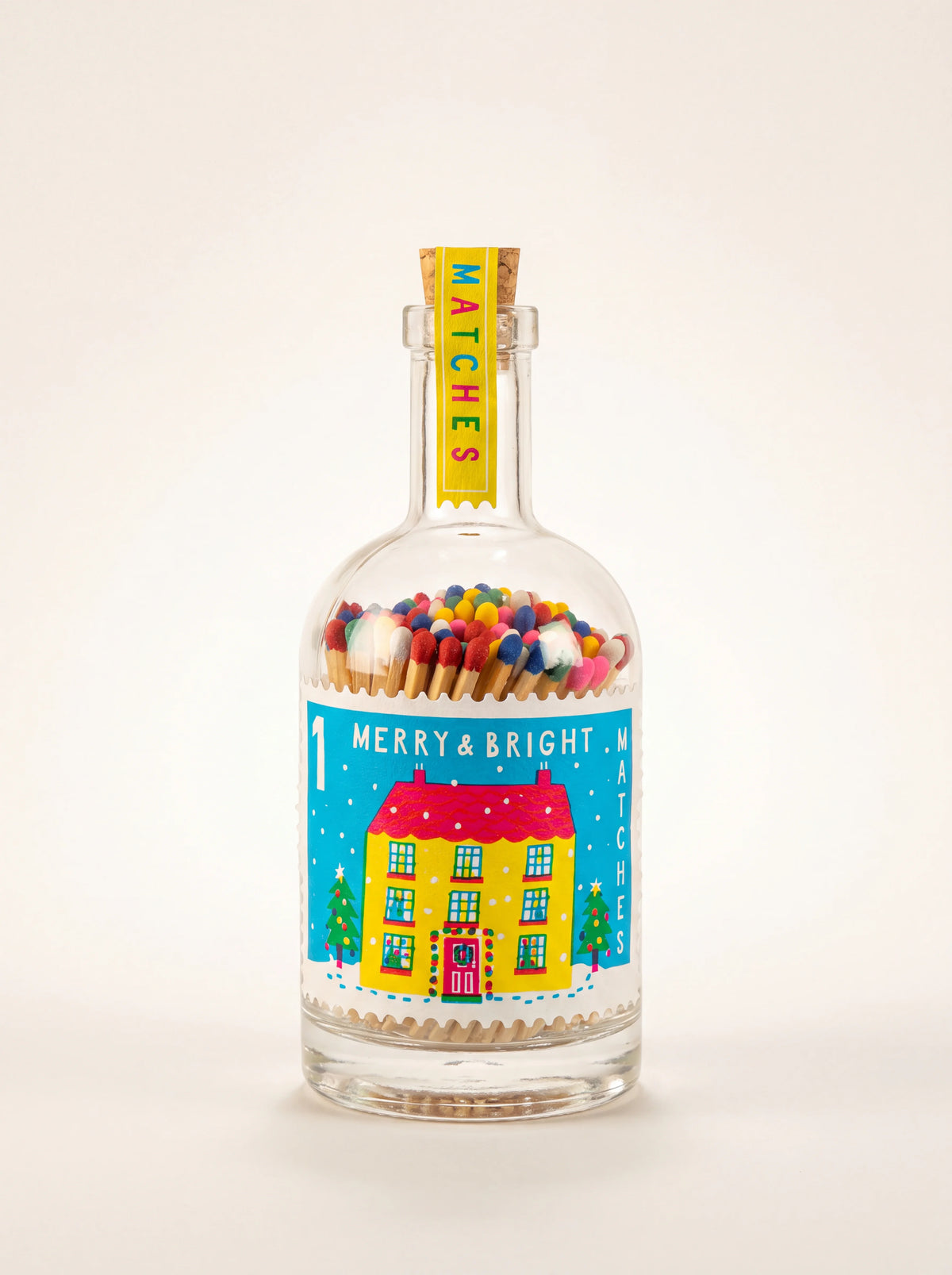 Glass bottle of multicoloured matches with cork stopper and Merry & Bright illustrated label