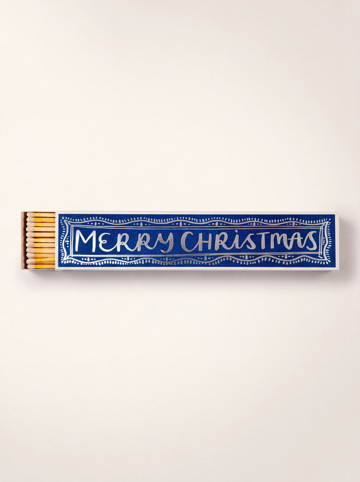 Long matchbox in blue printed with MERRY CHRISTMAS, partly slid open showing white-tipped matches