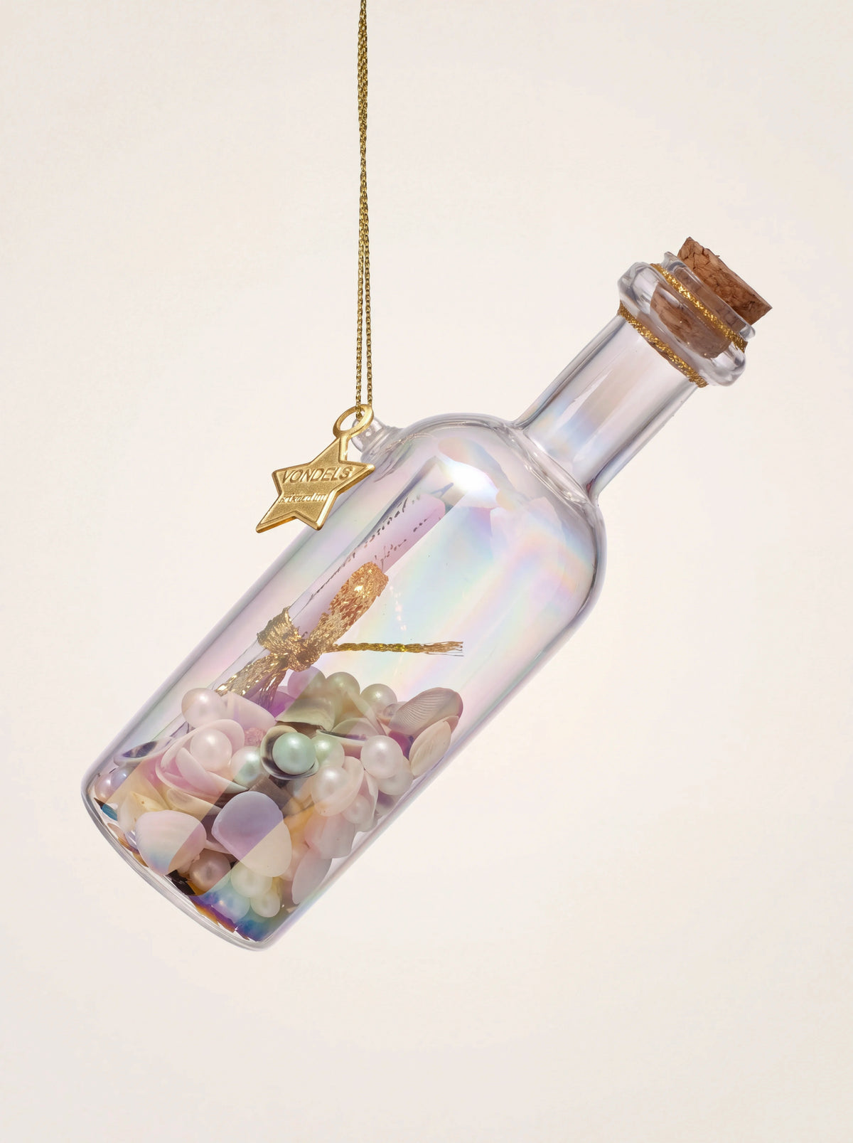 Iridescent glass bottle ornament with a cork stopper, filled with shells, faux pearls and a rolled message