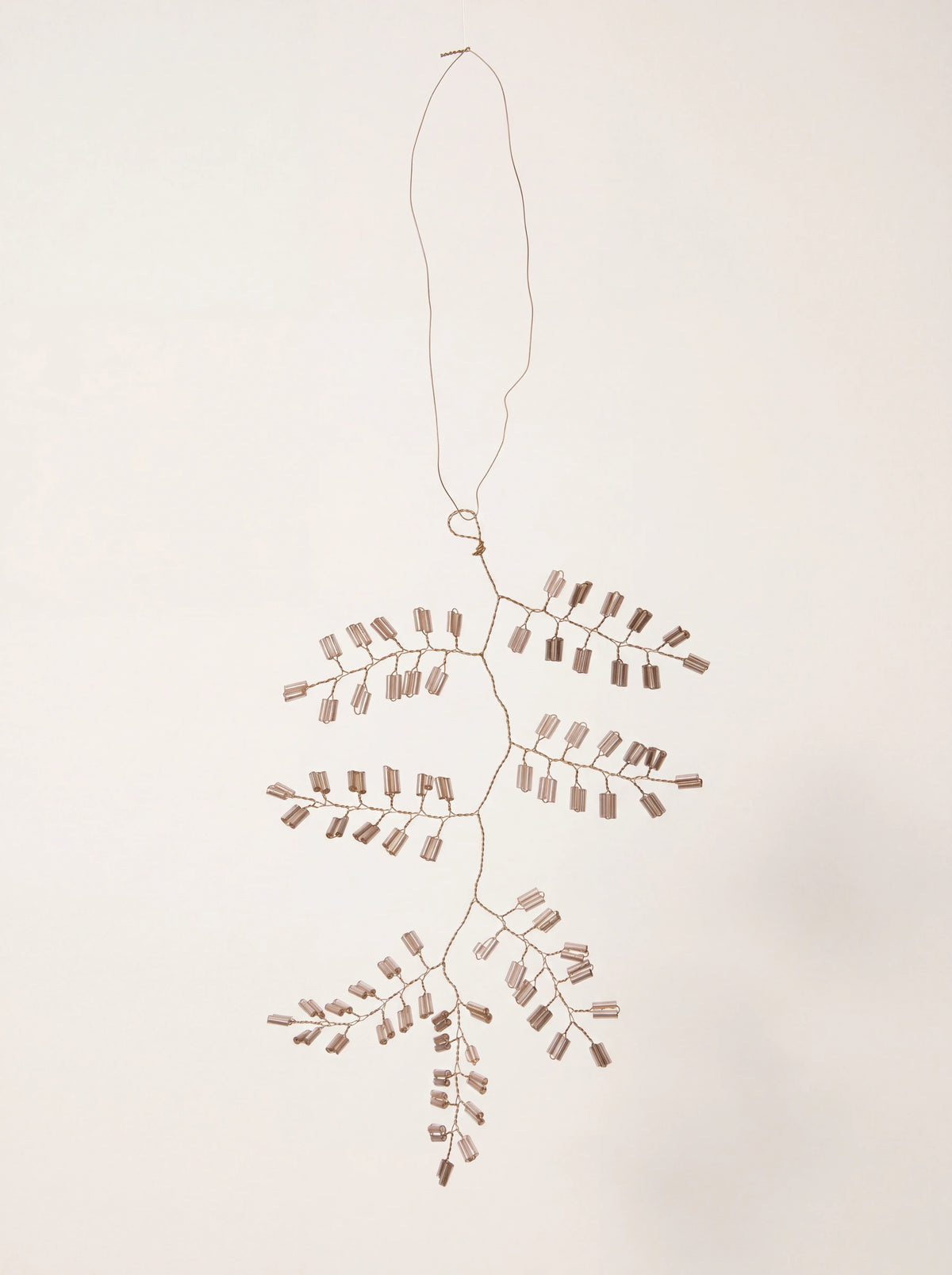 Twig-shaped ornament with champagne glass cylinder beads on fine wire branches and a hanging loop
