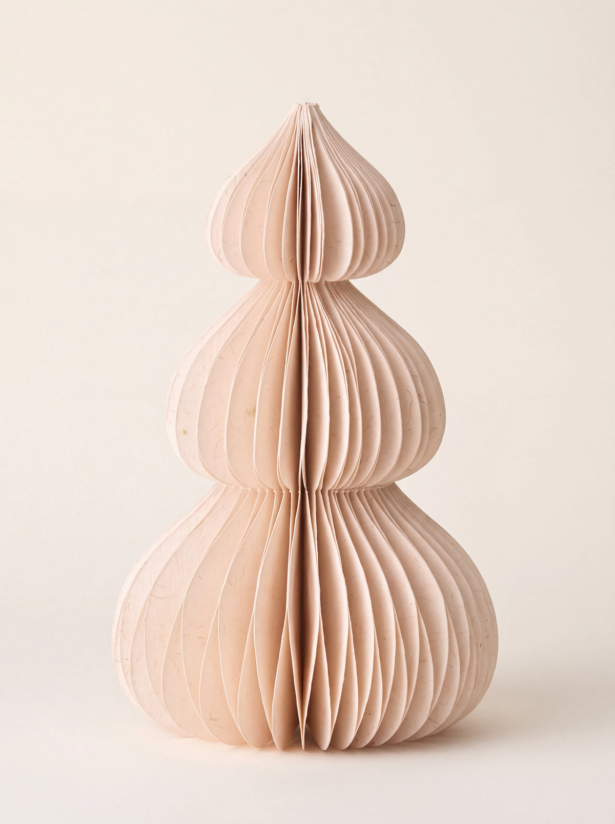 Three-tiered paper honeycomb tree ornament in powder pink