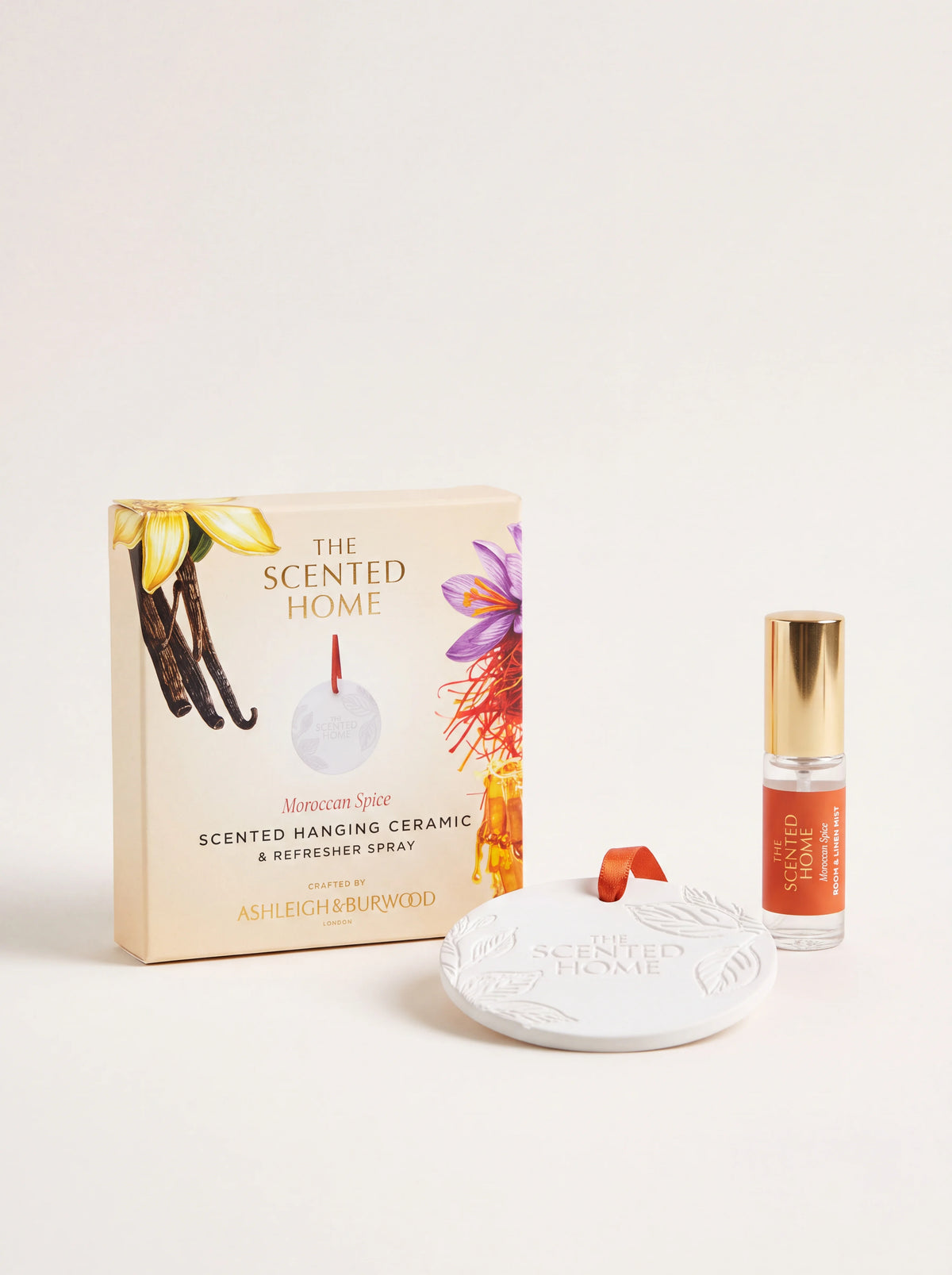Round white ceramic diffuser disc with a 5 ml refresher spray bottle and illustrated packaging box