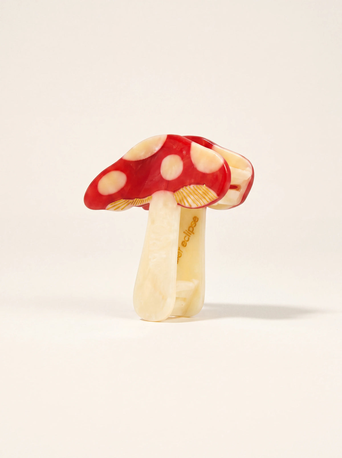 Mushroom claw clip in cellulose acetate with a red spotted cap and cream stem