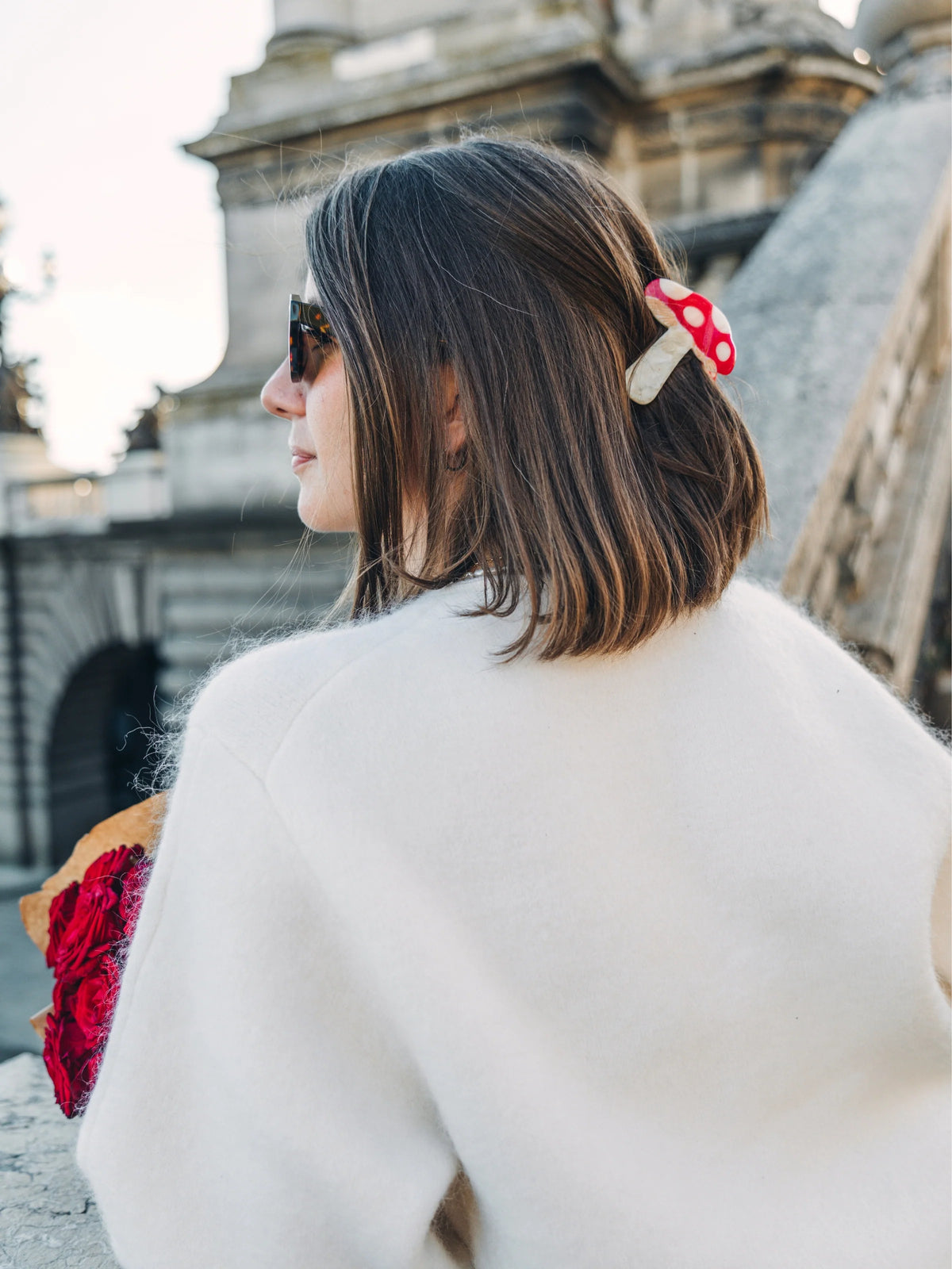 Mushroom claw clip worn in short brown hair to secure strands at the side