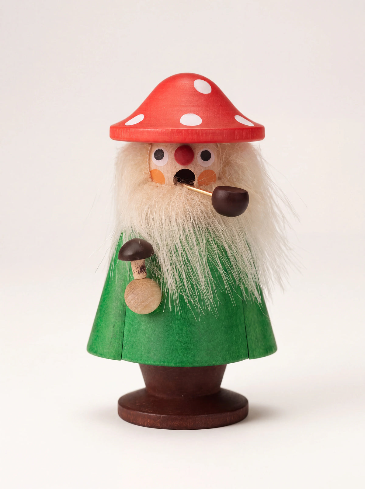 Mushroom wooden incense smoker figurine with a red spotted cap, fluffy beard, pipe, and green coat