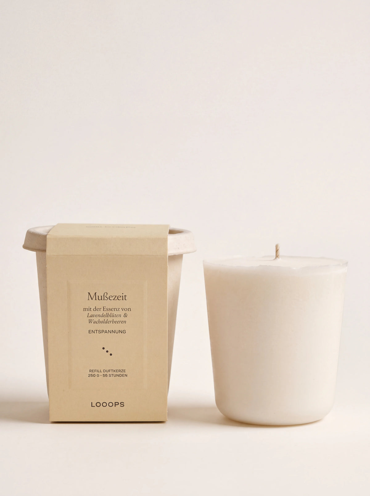 Vegetable wax scented candle refill standing next to its lidded bagasse packaging cup