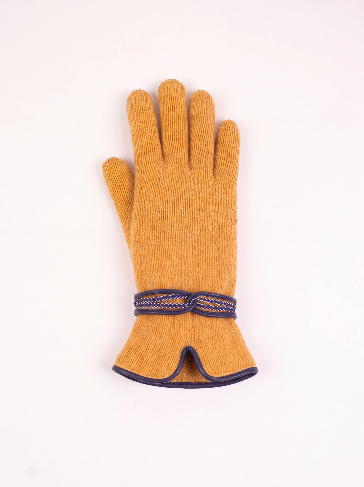 Mustard knitted wool and cashmere glove with a navy wrist strap and curved slit at the cuff