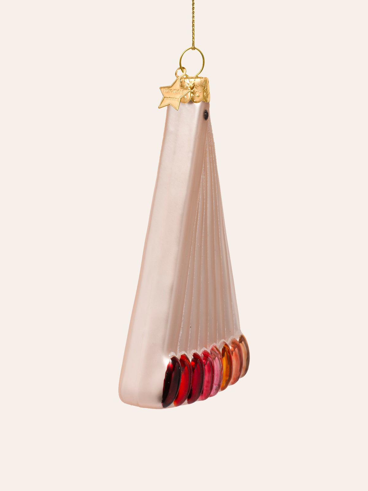 Side view of the nail swatches ornament showing its thickness and the curved row of glossy tips
