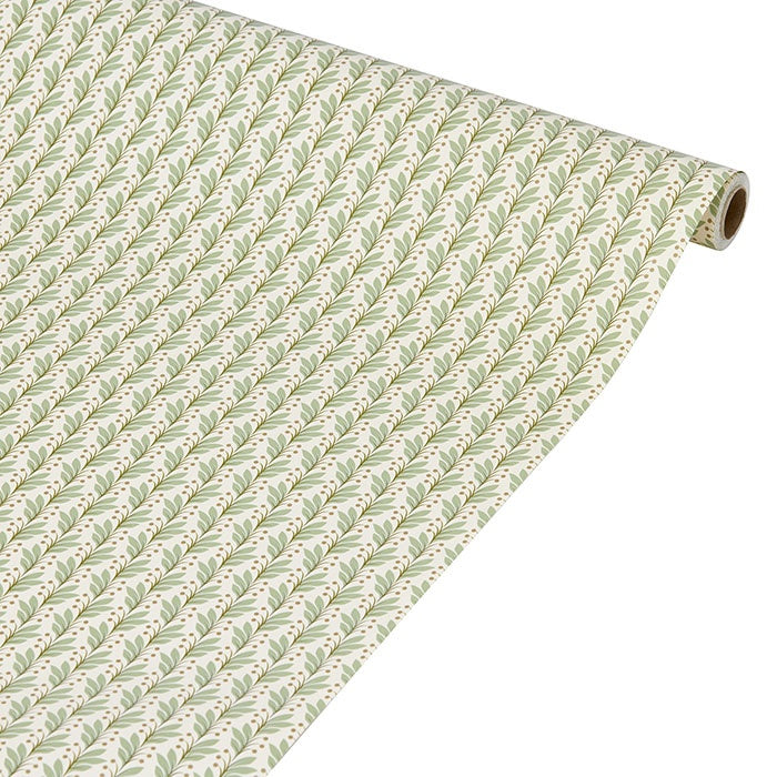 Wrapping paper roll with a repeating green botanical leaf motif on a cream background