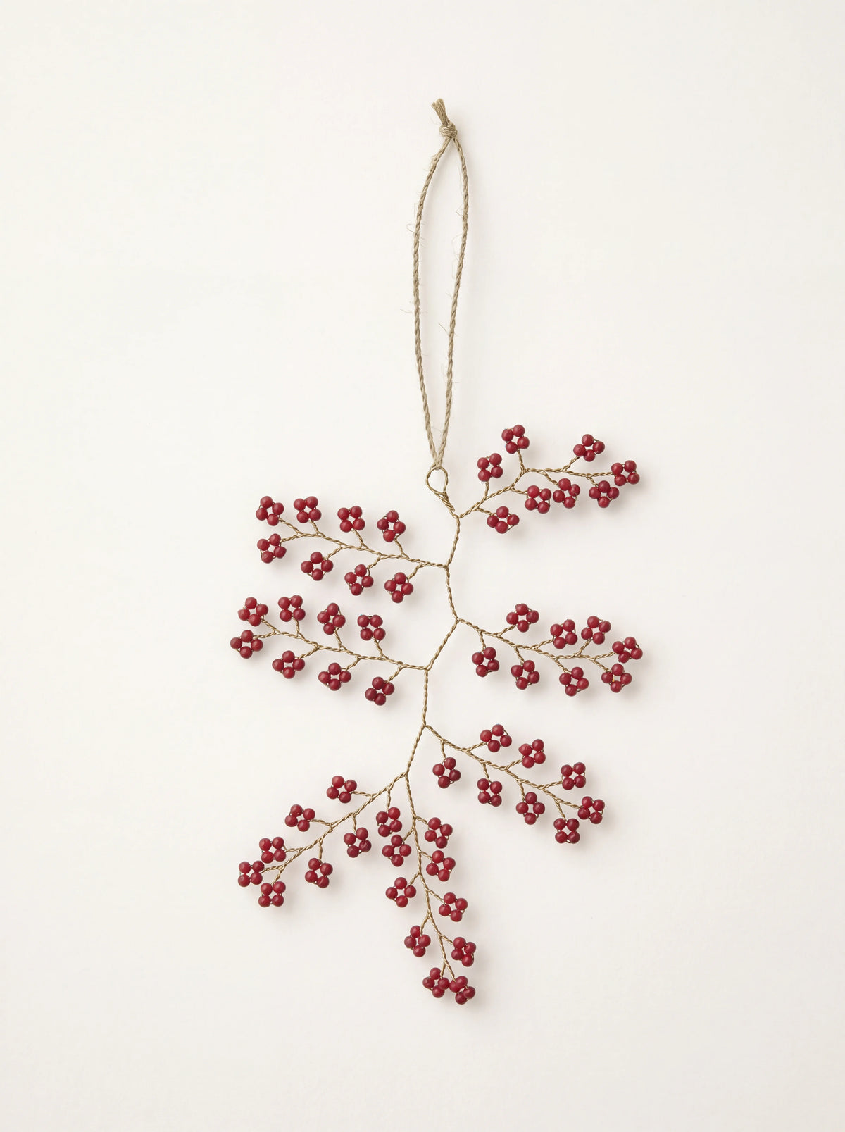 Hanging twig ornament made of twisted wire with clusters of ruby red beads and a cord loop