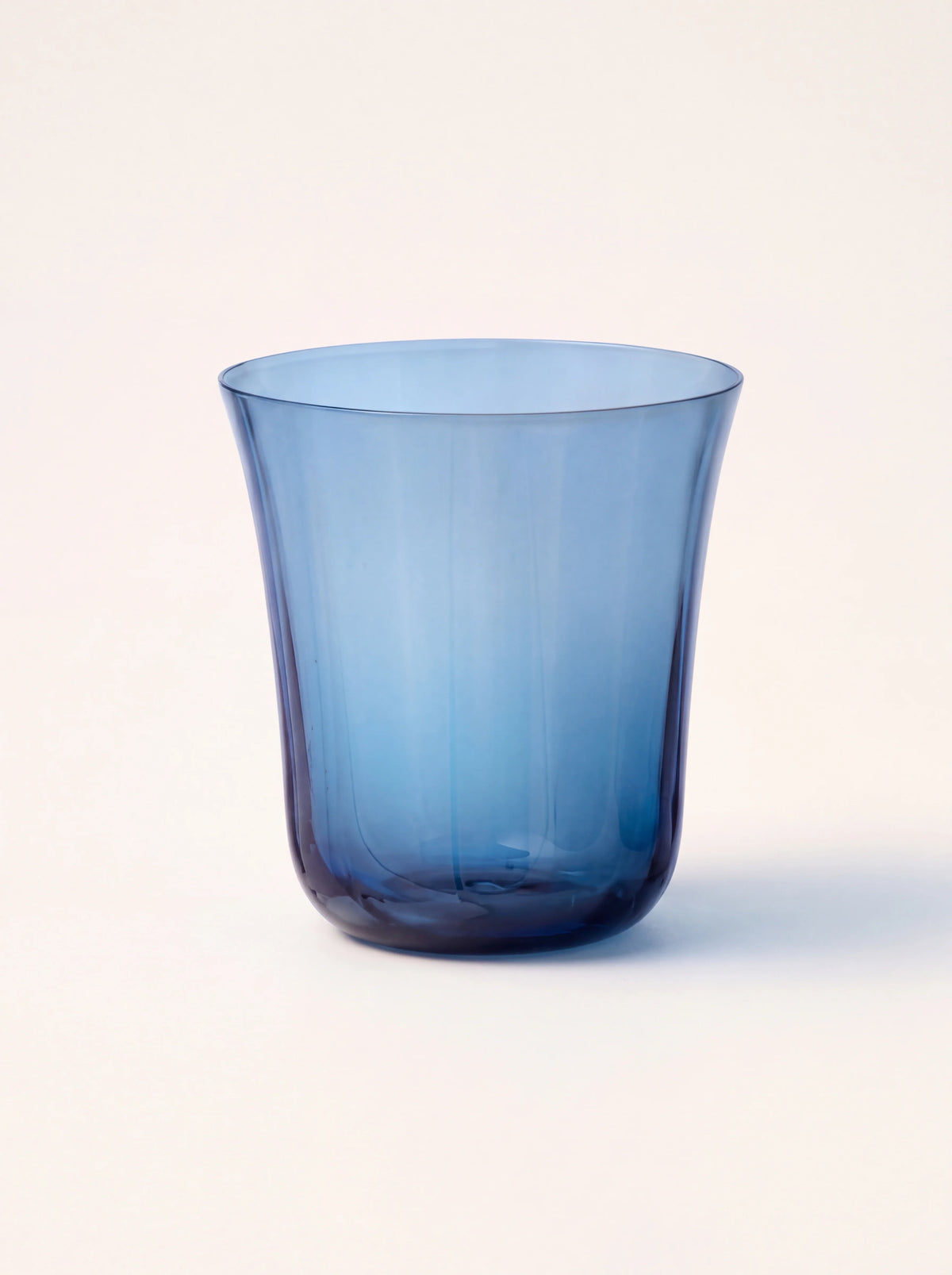 Mould-blown blue glass tumbler with fluted sides and a gently flared rim