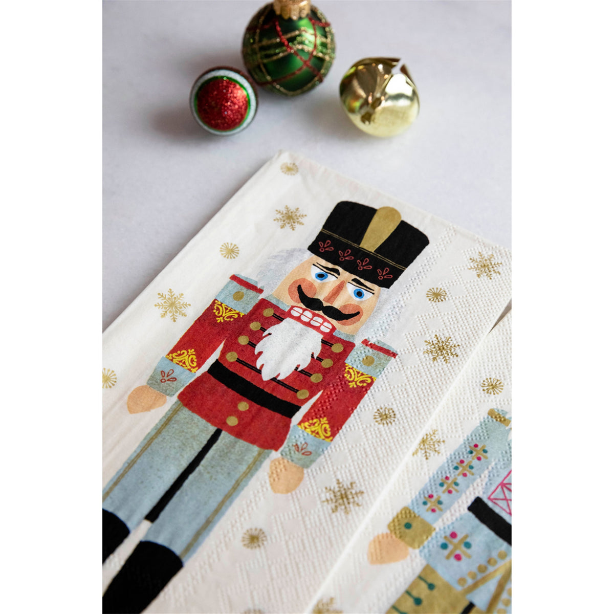 Close-up of the nutcracker paper napkin showing the textured surface, embossed border and print details