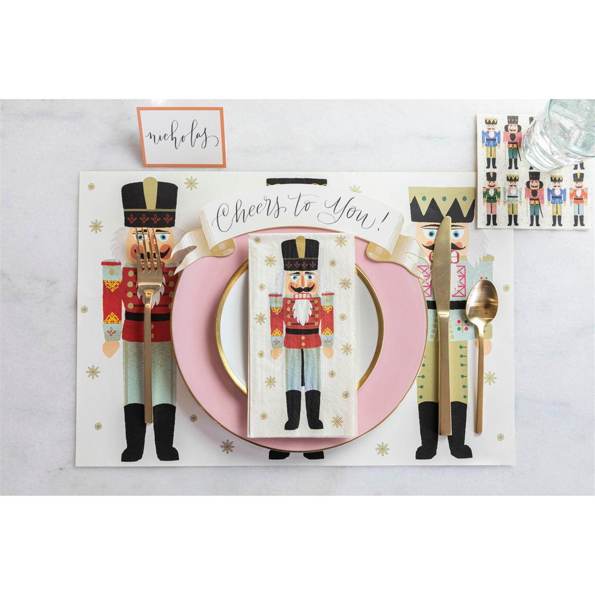 Nutcracker paper guest napkin arranged on a round plate as part of a Christmas table setting