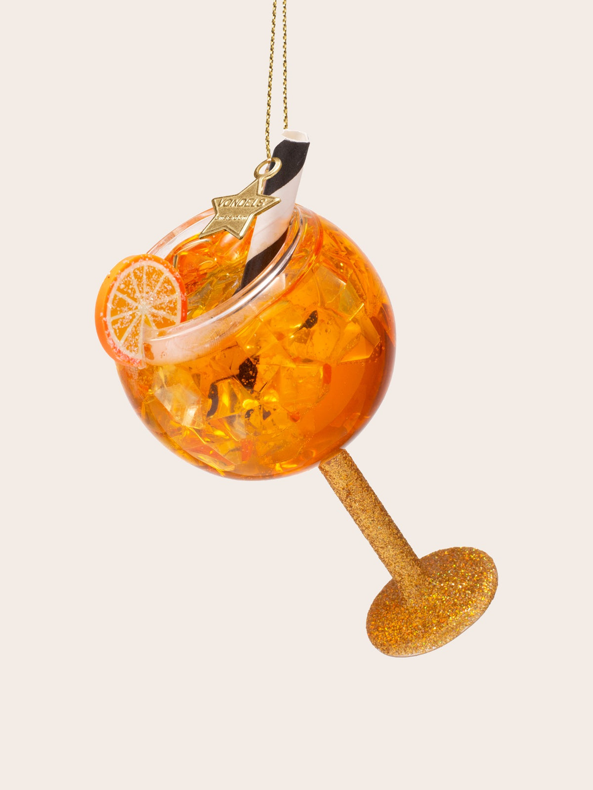 Angled view showing inside the glass bowl filled with ice cubes, a striped straw, and sliced orange garnish
