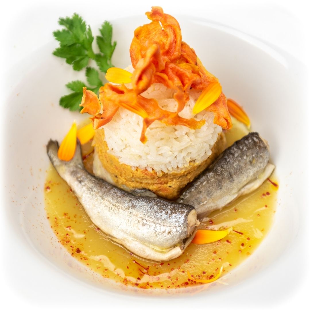 Serving suggestion showing two mountain trout with rice and garnish in a shallow bowl