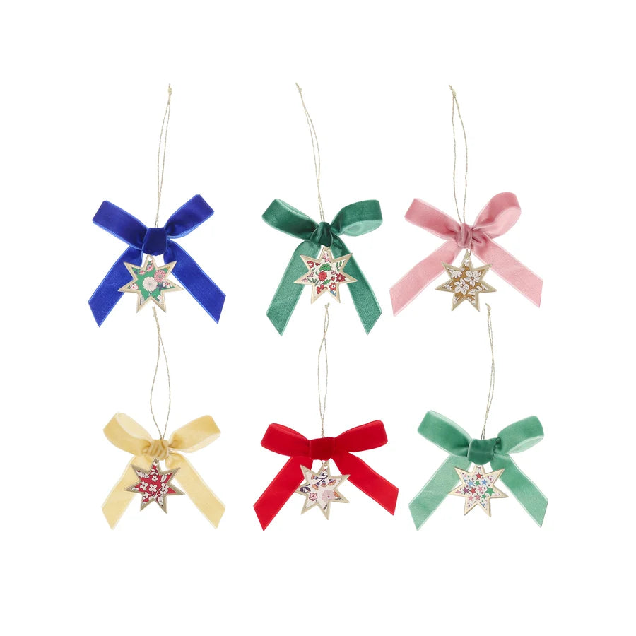 Six hanging star decorations with floral paper centres, gold borders and assorted coloured velvet bows