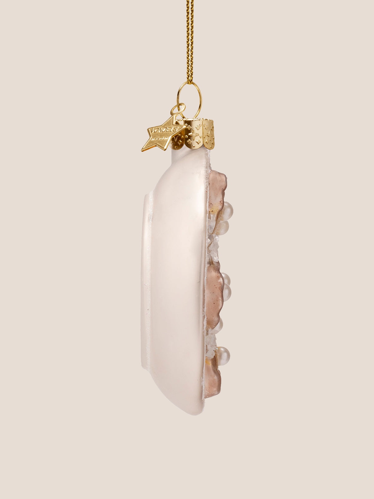 Side profile of the oyster plate ornament showing its shallow dish depth and smooth white back
