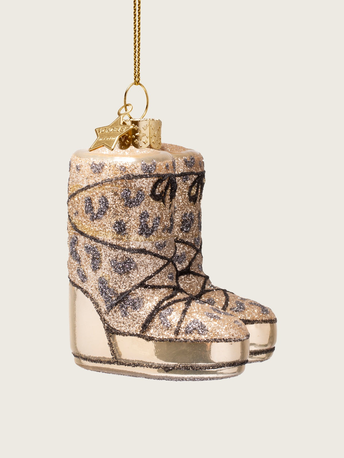 Side view of the glass snow boots ornament, showing the boot profile and thick metallic soles