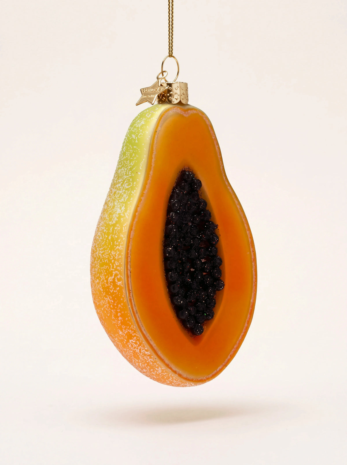 Halved papaya glass Christmas ornament with orange flesh, dark beaded seeds and a frosted rind