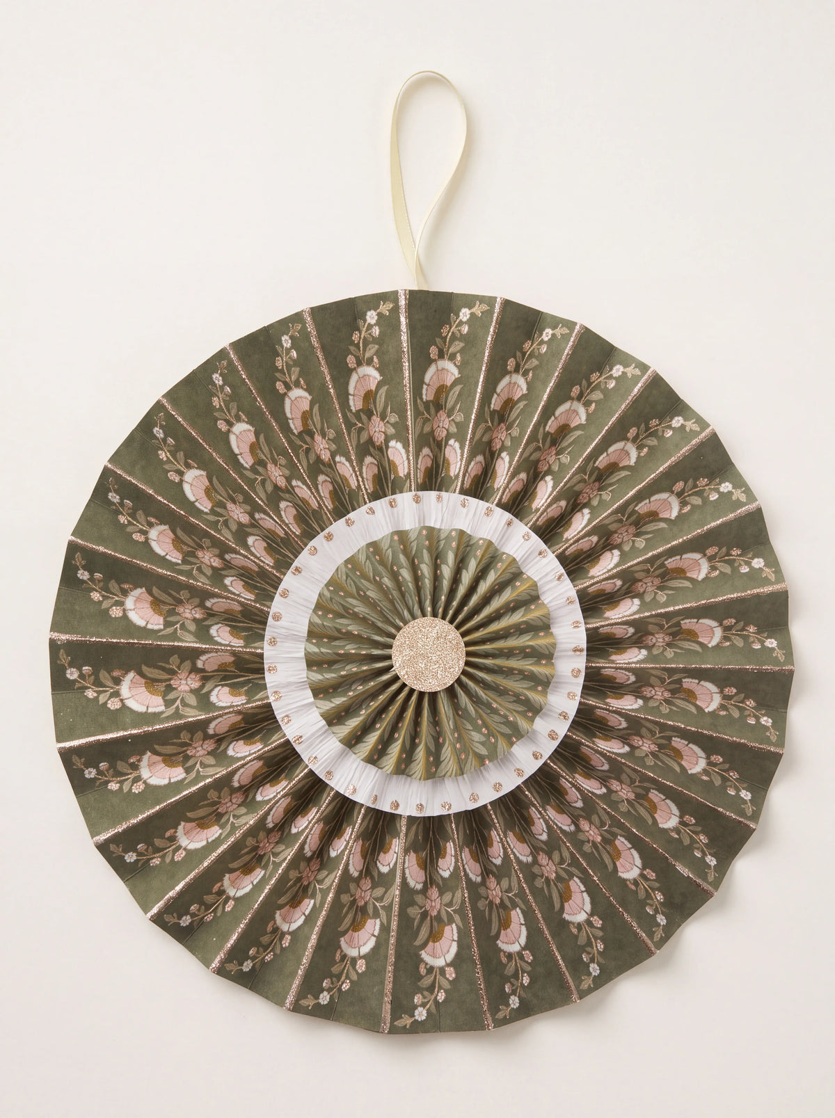 Pleated olive cotton paper rosette with floral print, glitter accents, and a hanging ribbon loop