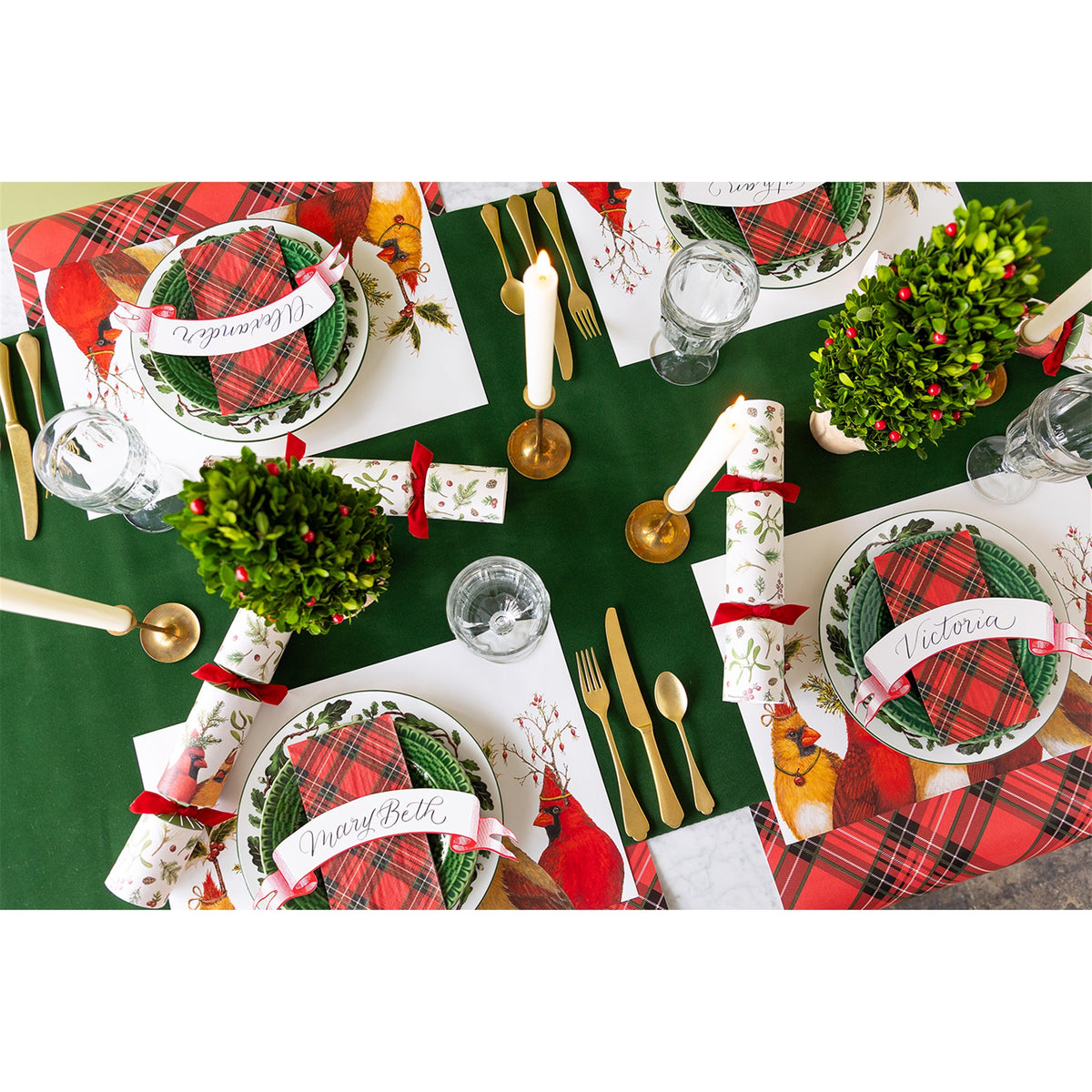 Paper ribbon banners used as place cards with handwritten names across festive place settings
