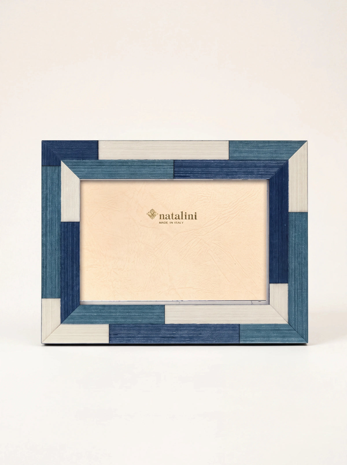 Inlaid wood photo frame with a blue and white parquet pattern and insert card reading natalini MADE IN ITALY