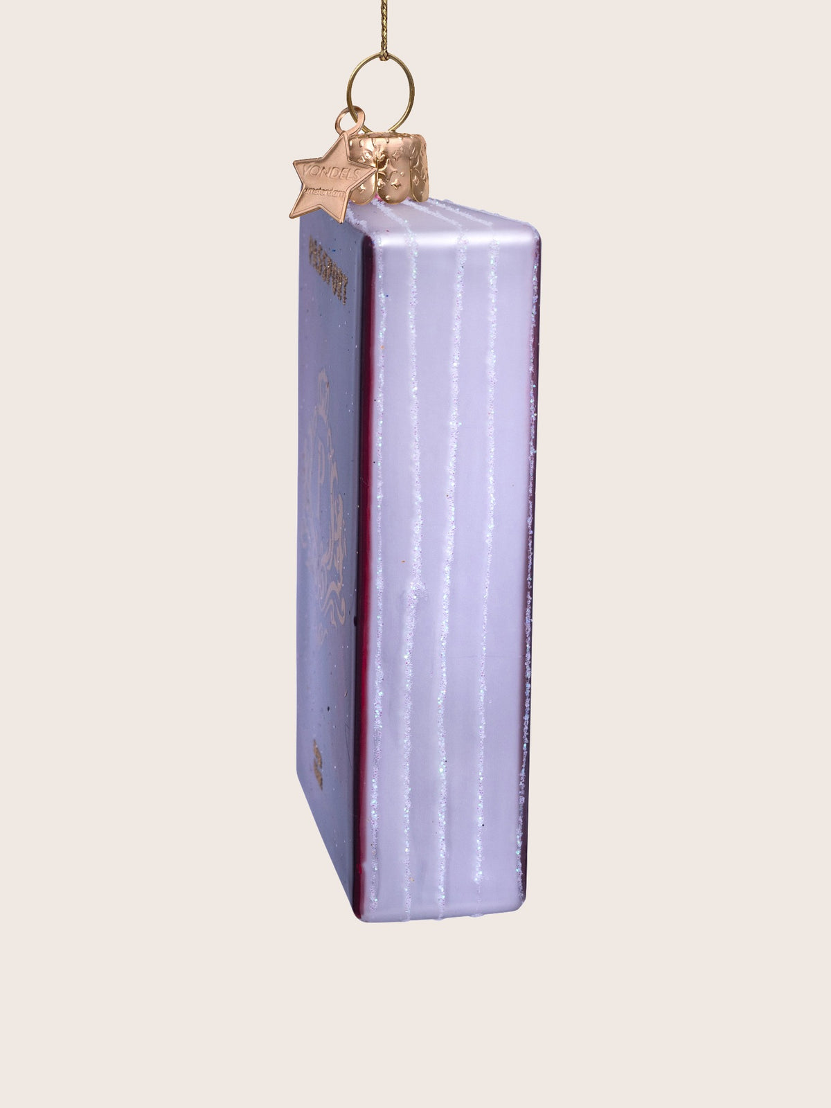 Side profile showing the thickness and white glitter-detailed page edges of the glass ornament