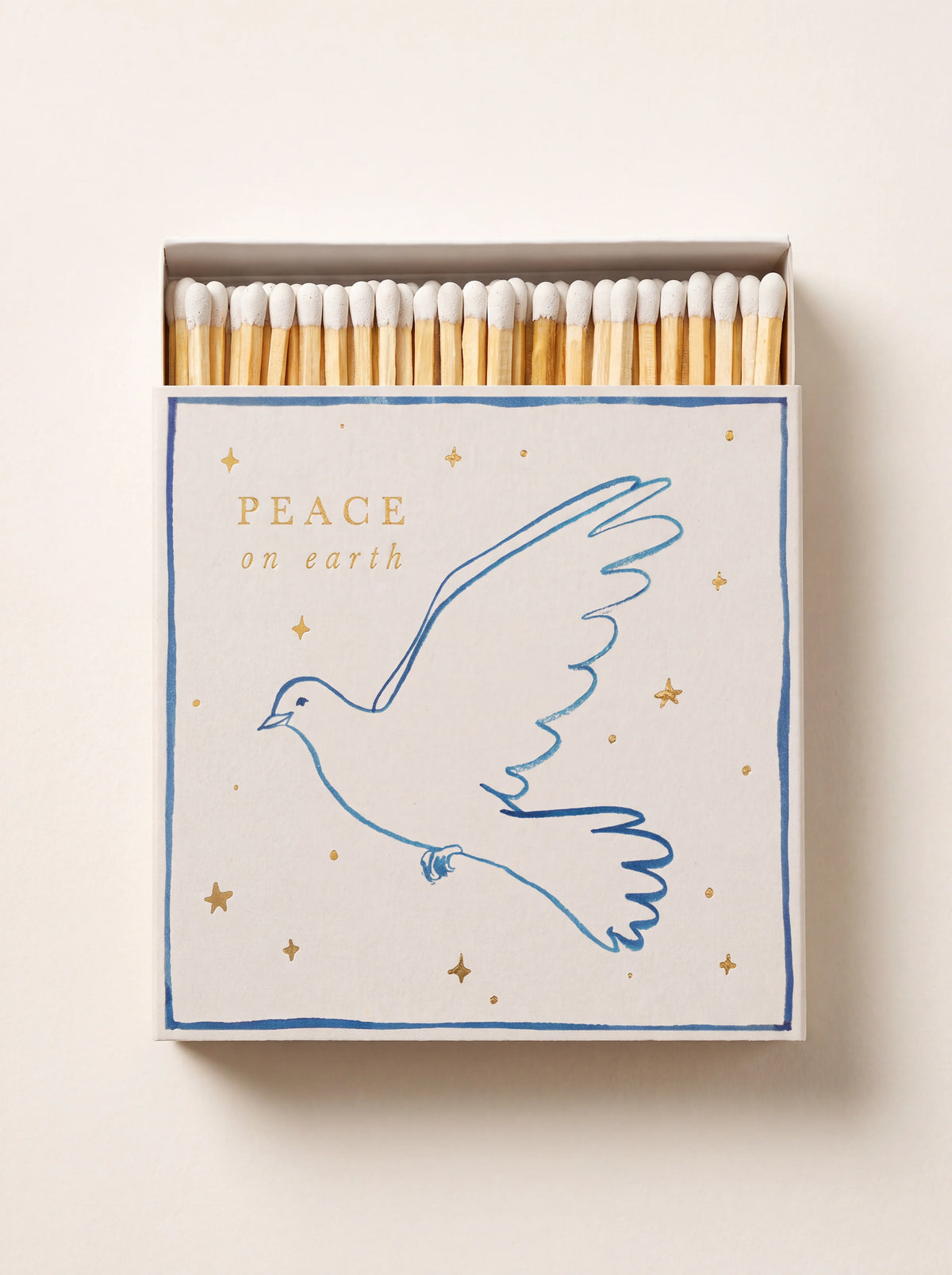 Square matchbox with white-tipped matches, decorated with a blue dove outline and text reading PEACE on earth