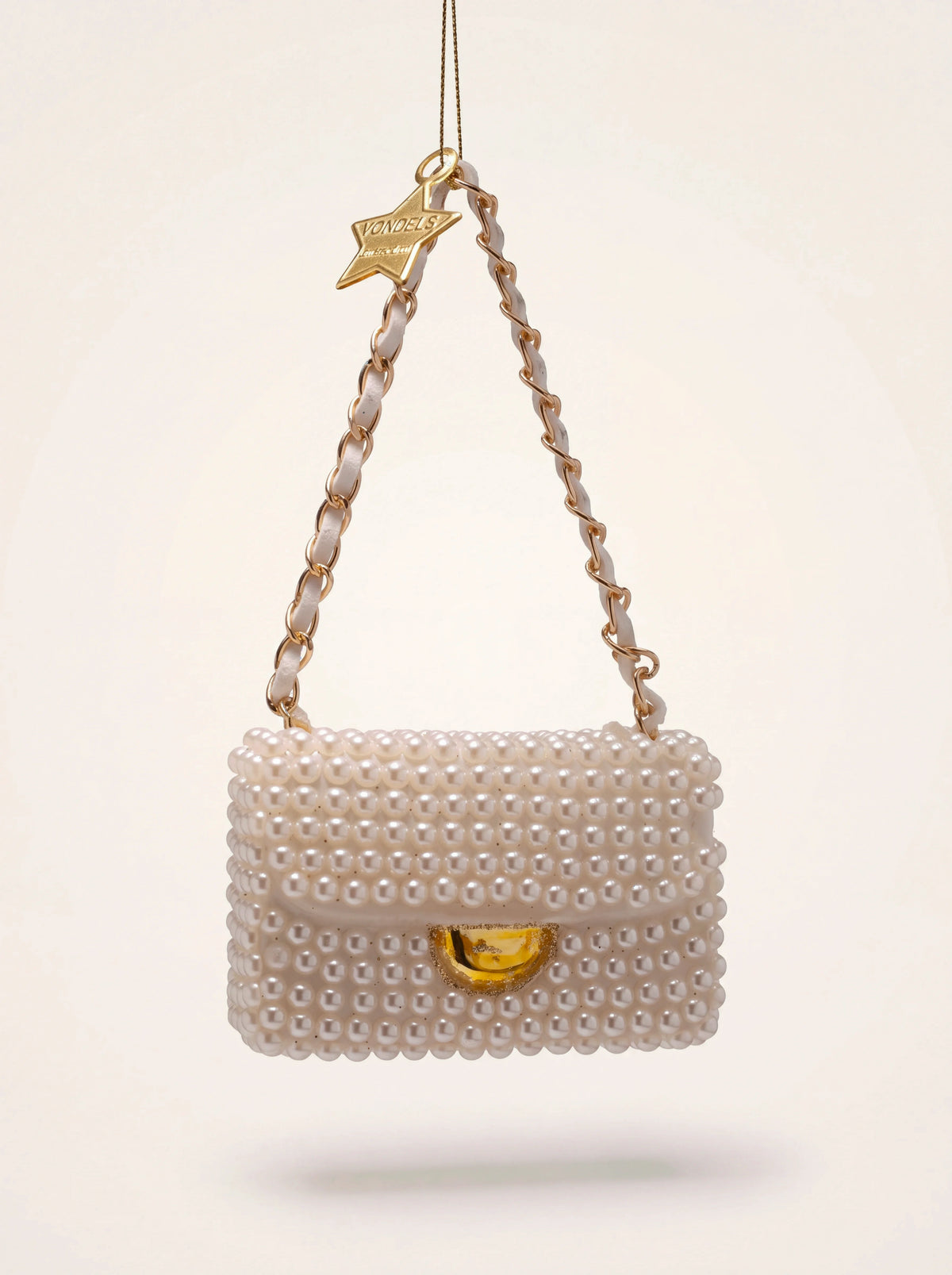 Glass handbag Christmas ornament covered in pearlescent beads, with a gold chain strap and star tag