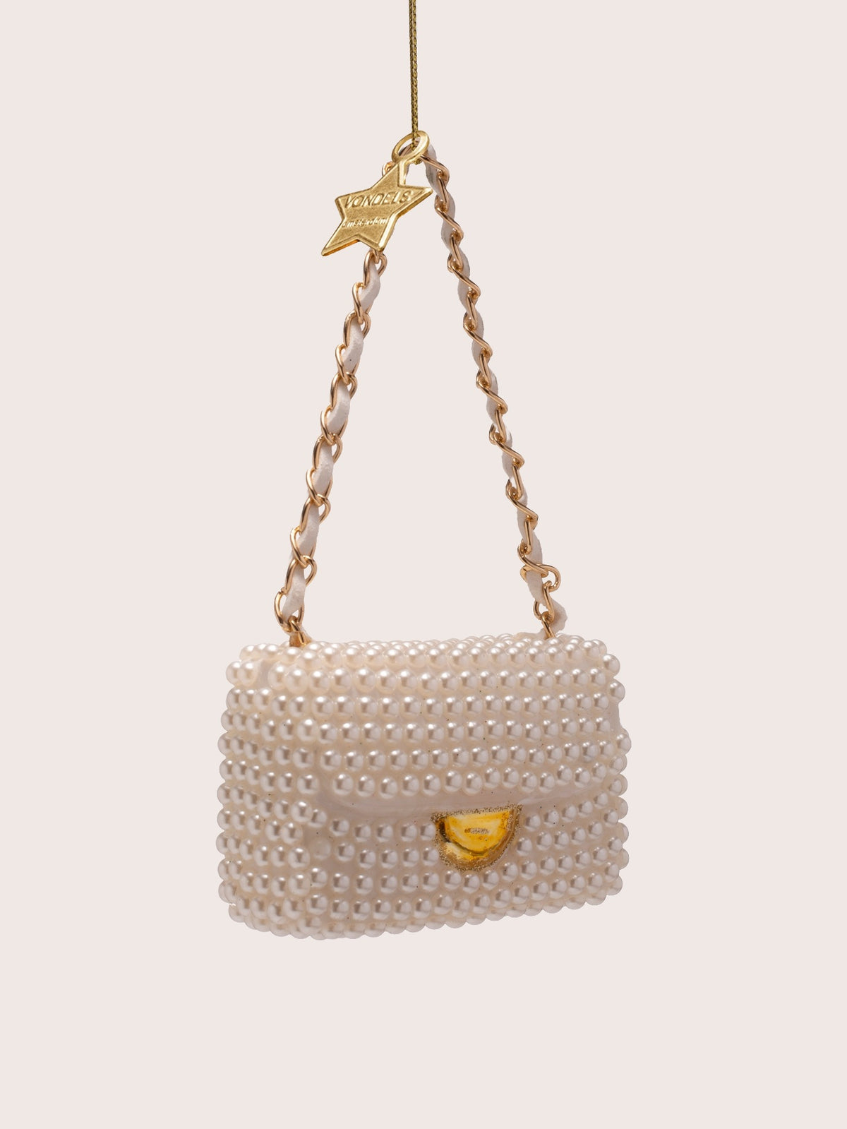 Three-quarter view of the pearl handbag ornament showing the front flap and gold-tone clasp