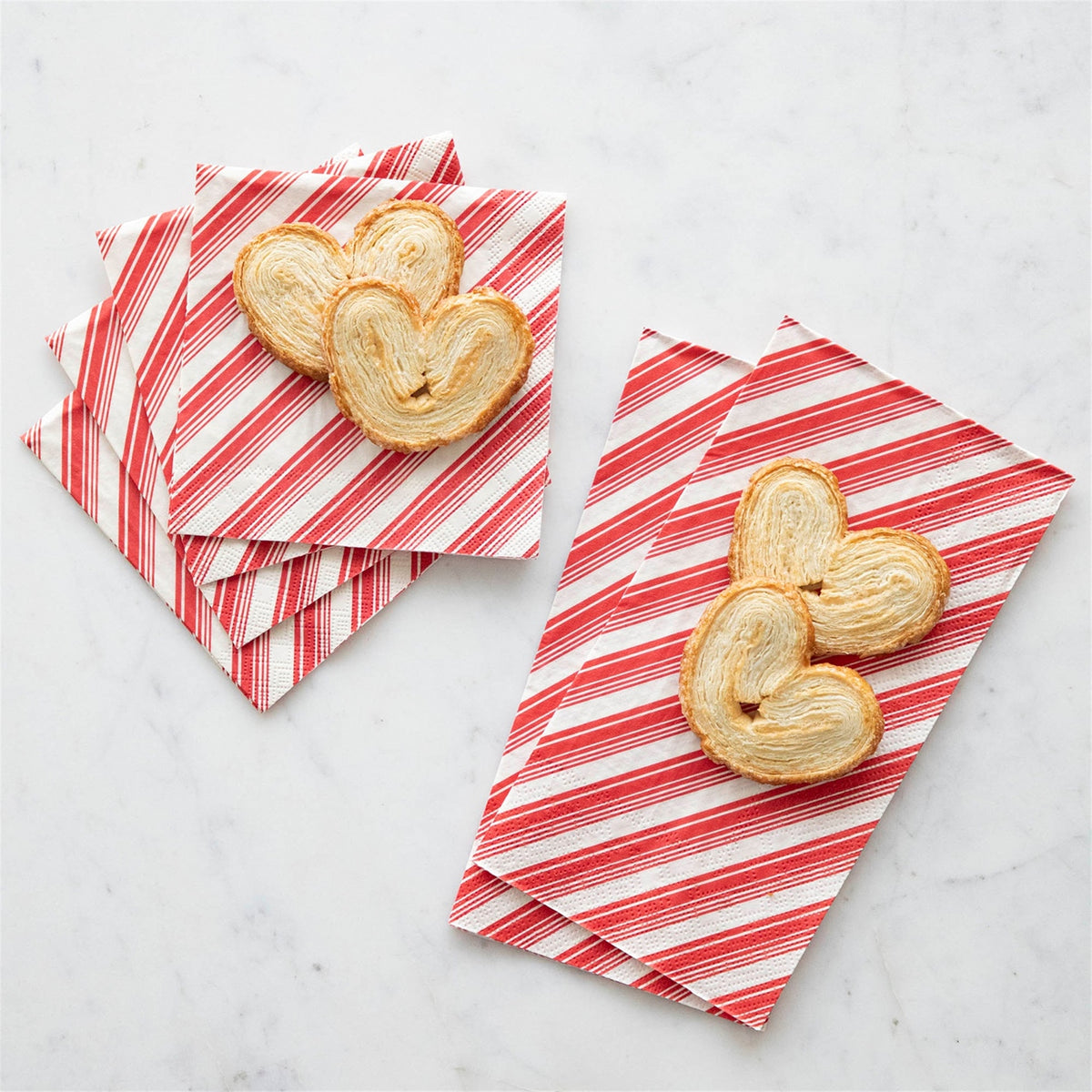Square and rectangular red striped paper napkins presented with palmier pastries