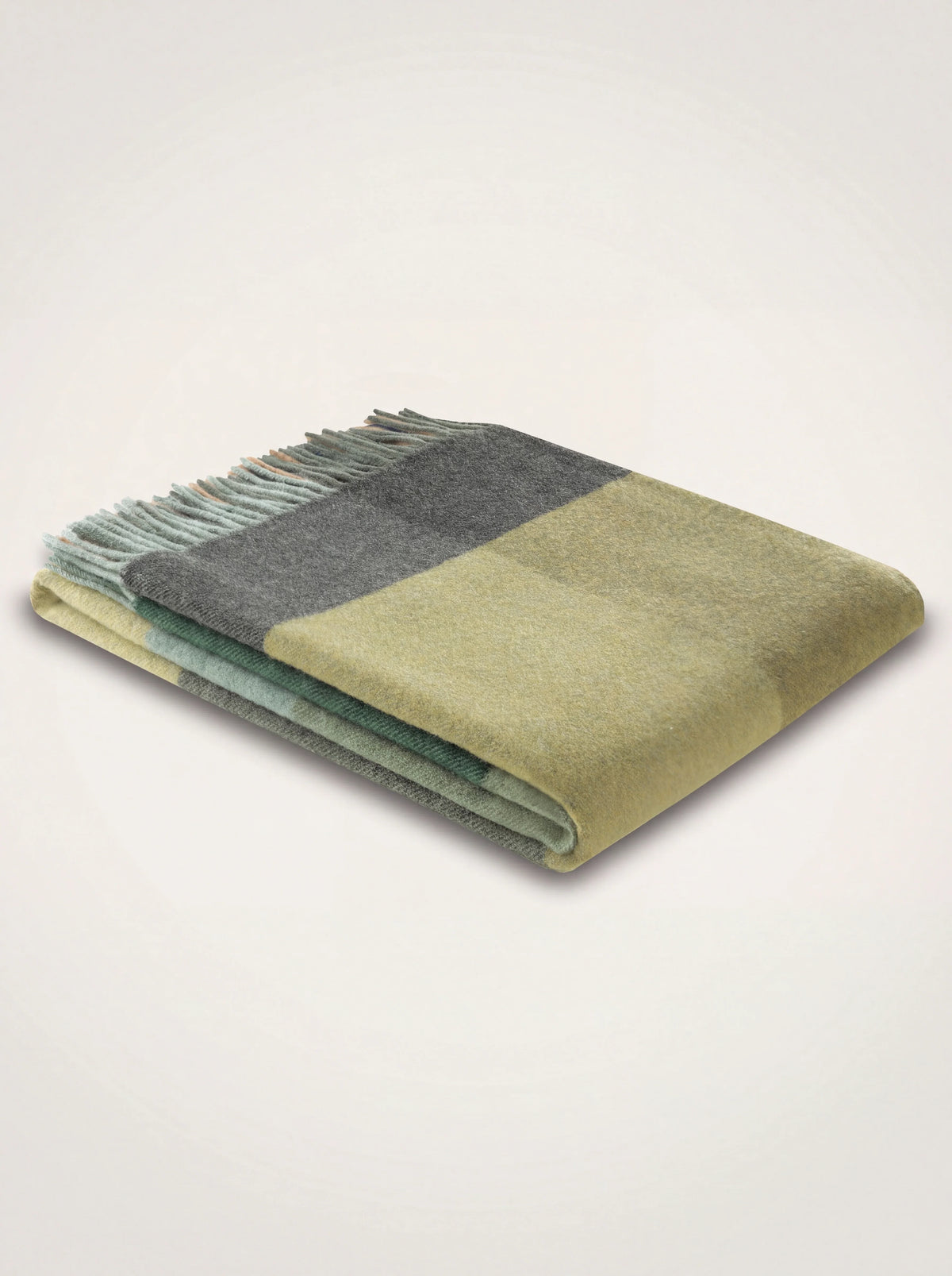 Wool and cashmere blanket folded in a green and grey check pattern with fringed ends