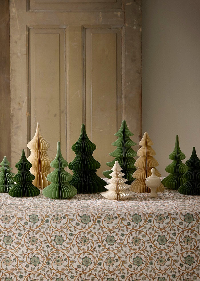 Paper honeycomb tree styled with matching paper trees in green and cream on a floral tablecloth