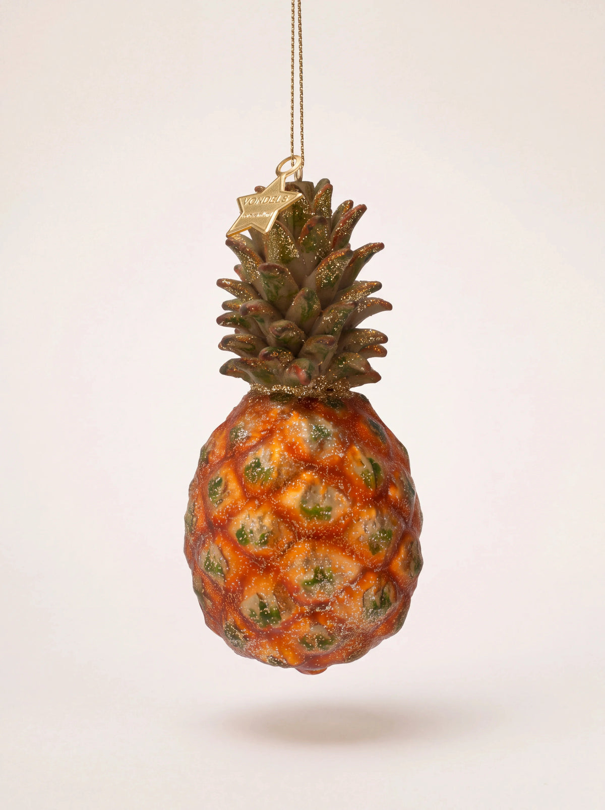 Pineapple Christmas tree ornament in mouth-blown glass with orange facets, green leaves and gold glitter