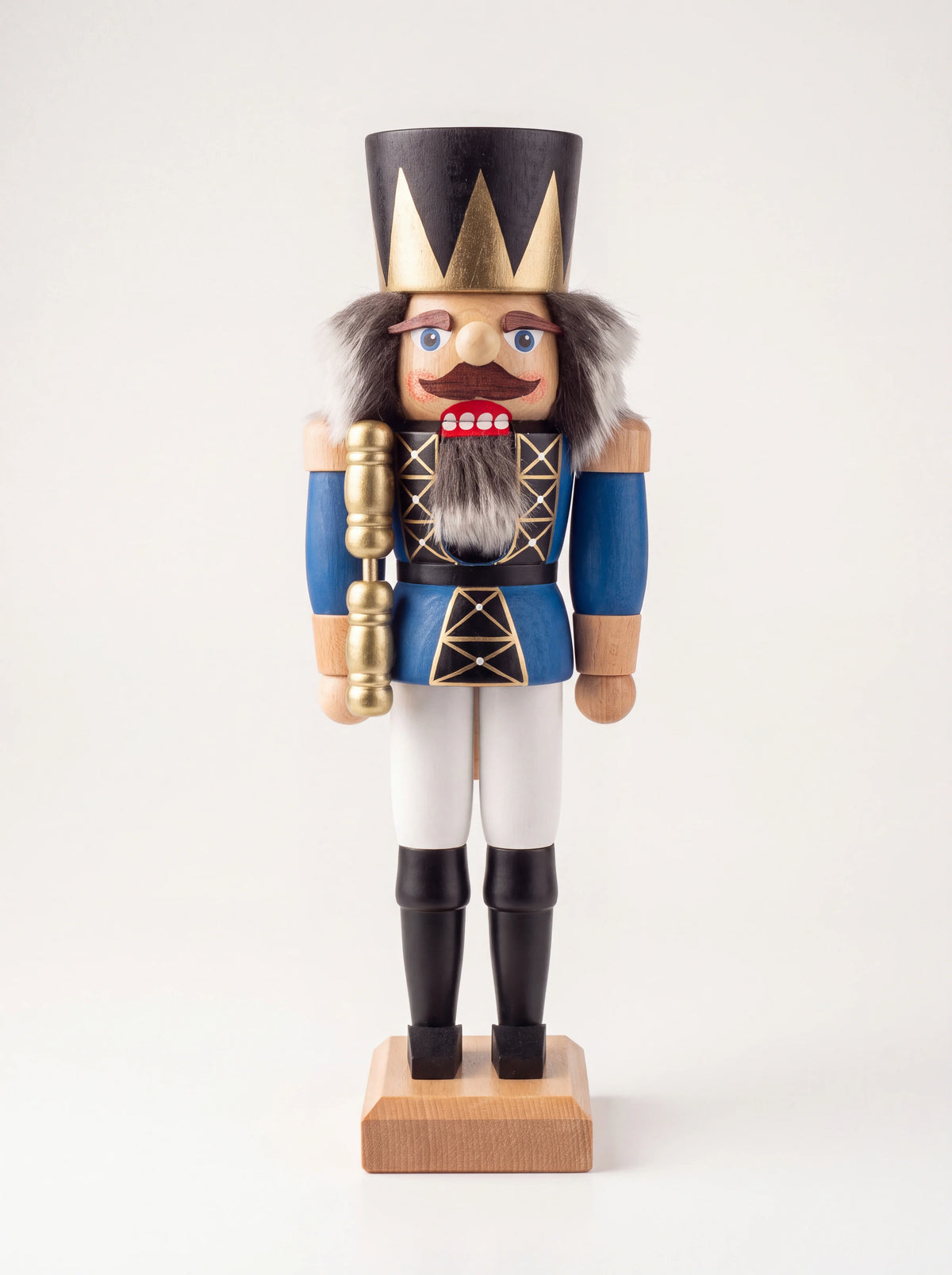 Blue wooden king nutcracker with a pointed gold crown, faux-fur hair, and sceptre on a wooden base