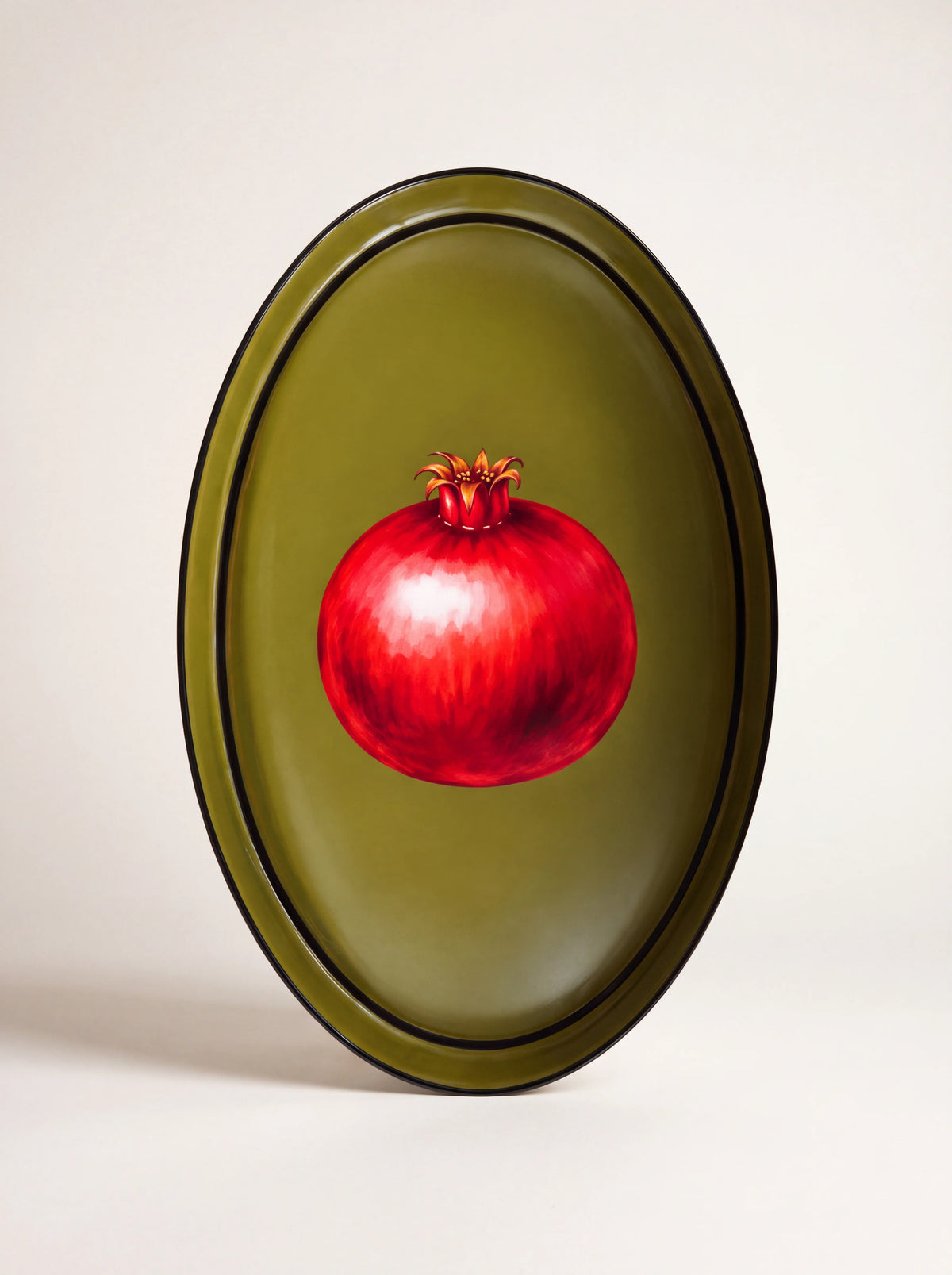 Oval olive green iron tray with a raised rim and a painted red pomegranate motif in the centre