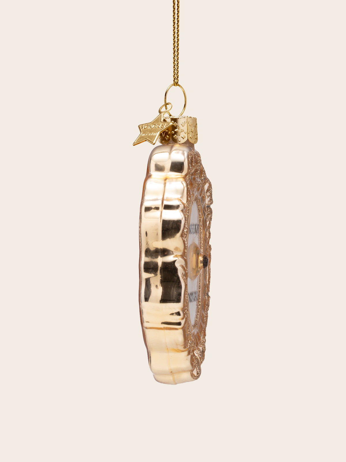 Side profile showing the raised central button and depth of the glass ornament