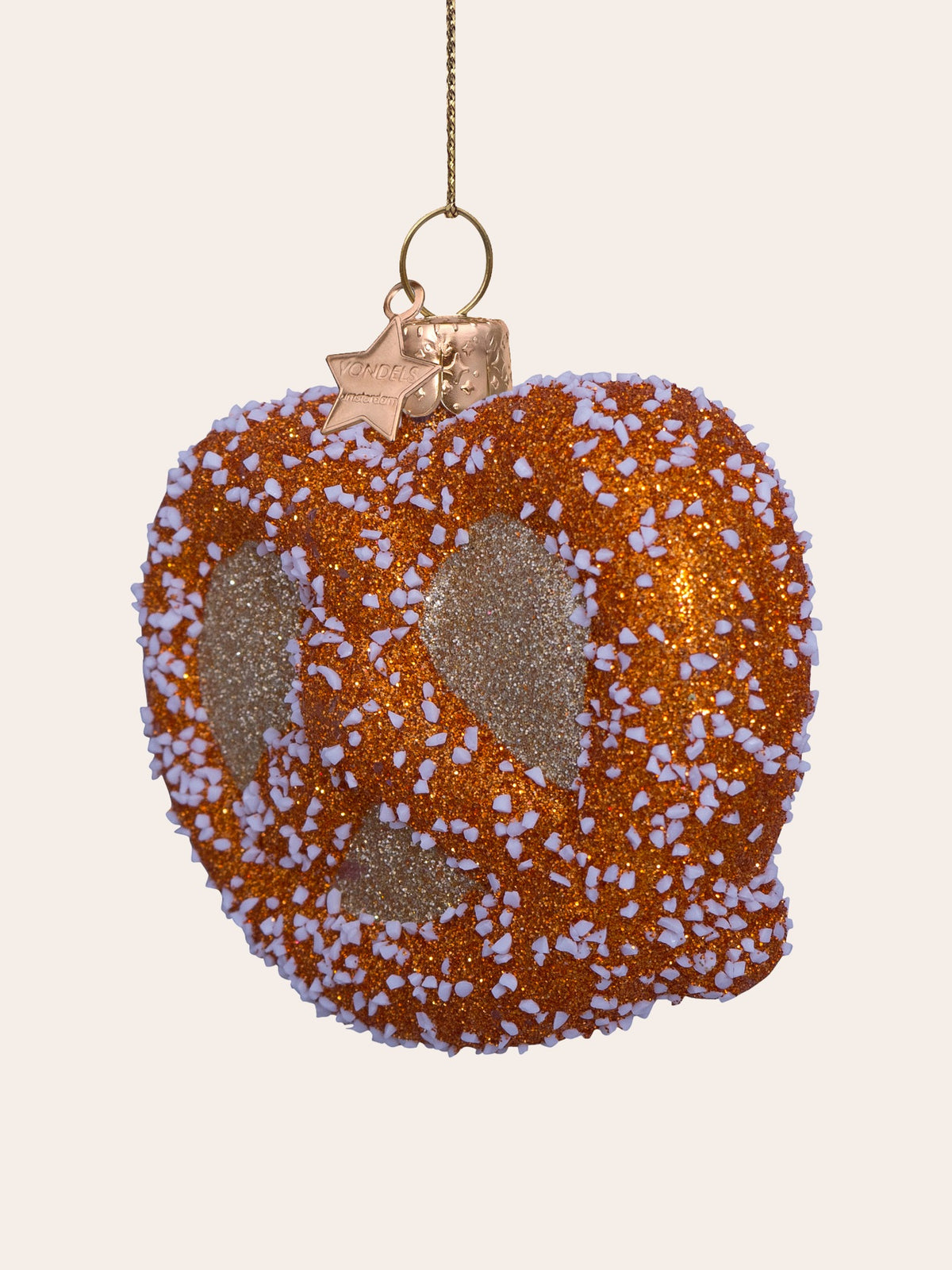 Three-quarter view of the glitter pretzel ornament showing its rounded profile and textured surface