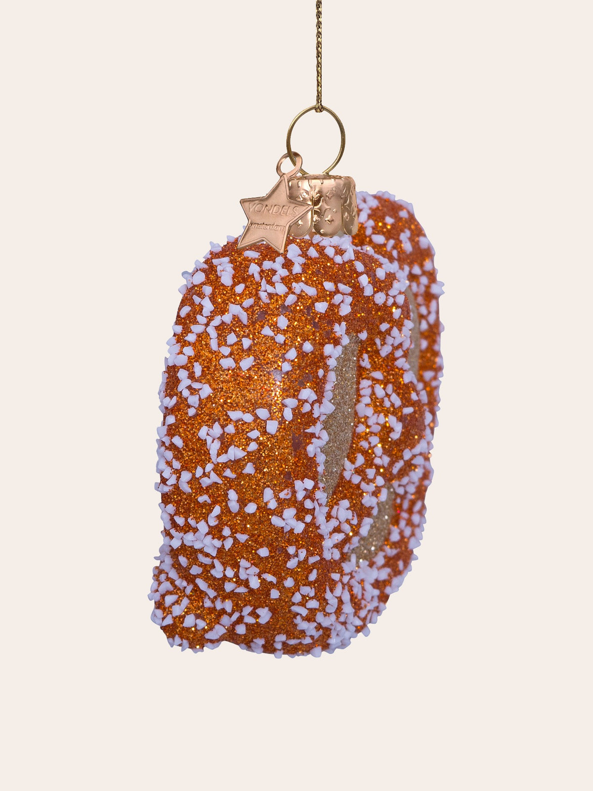 Side view showing the thickness of the glass pretzel ornament and its embossed metal hanging cap