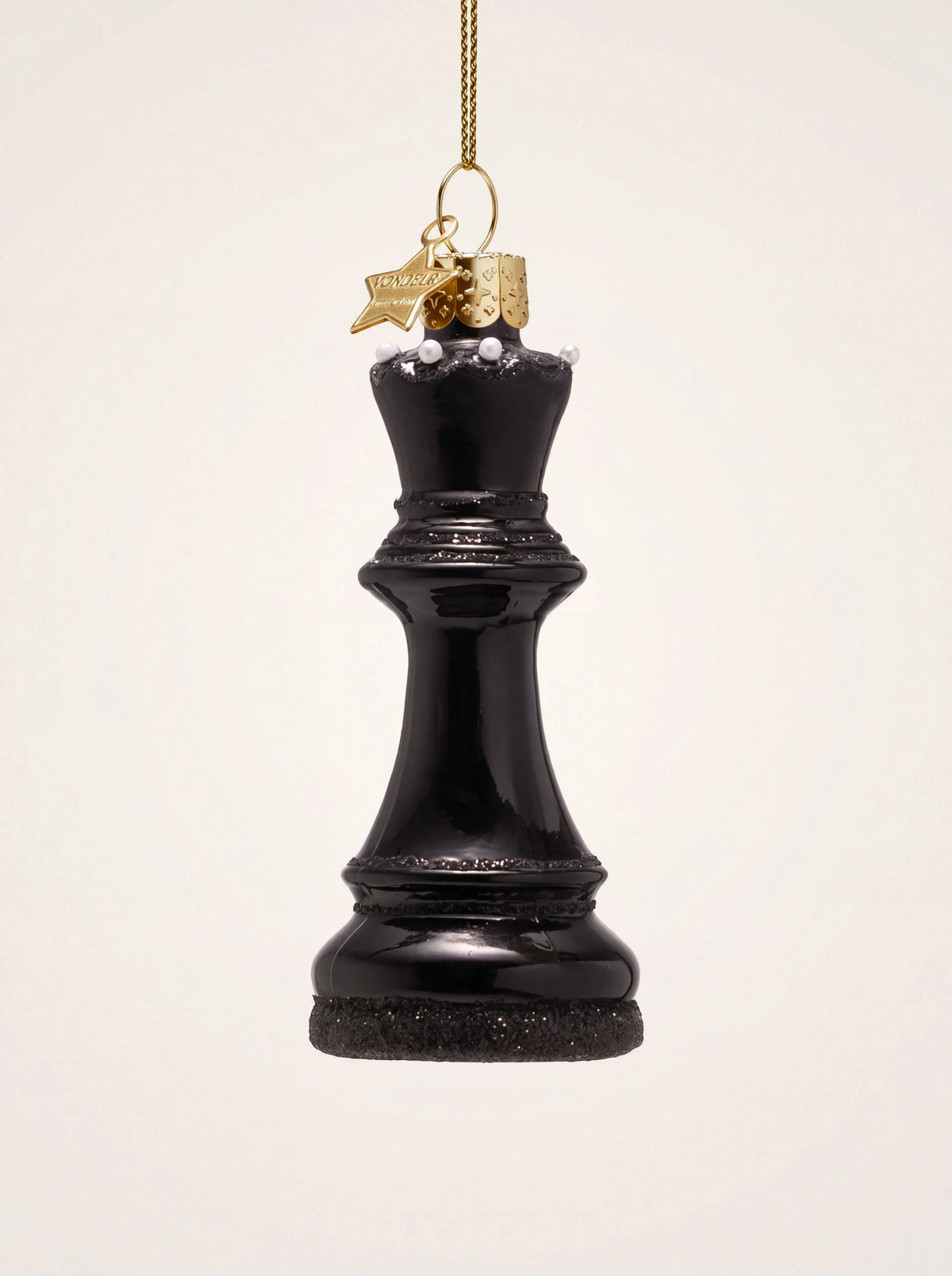 Glossy black glass queen chess piece ornament with glitter accents and a gold hanging cord