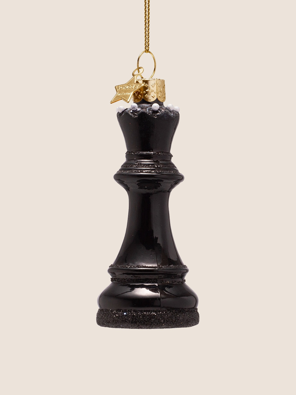 Turned view showing the gold star charm and embossed hanging cap above the crown