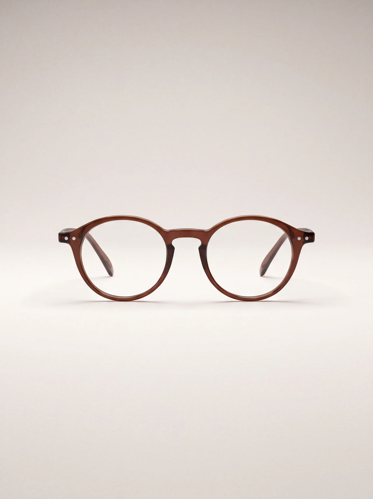 Round reading glasses with a glossy translucent espresso-brown frame and keyhole bridge
