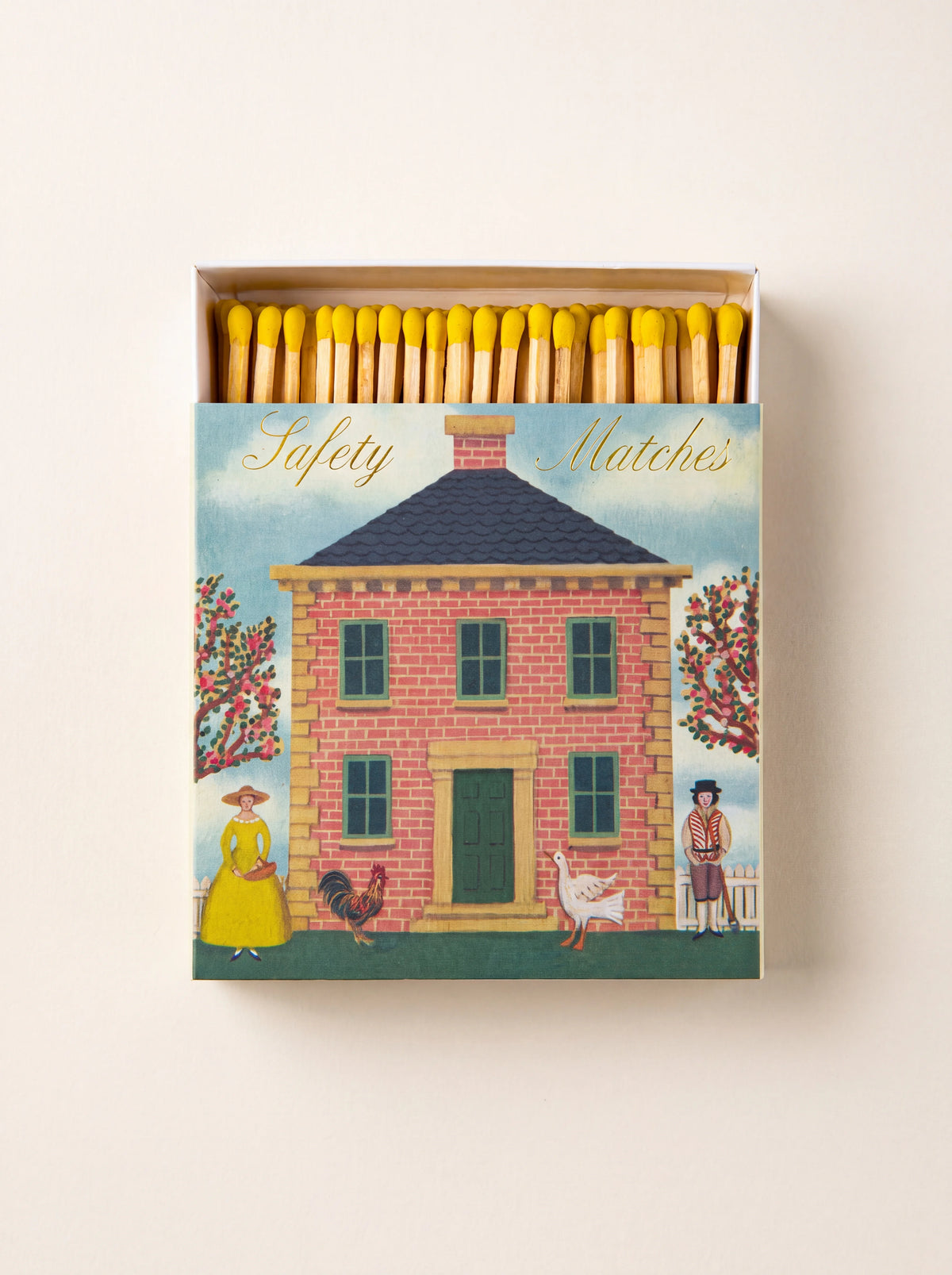 Matchbox partly open showing yellow match heads, illustrated with a red brick house and text reading Safety Matches