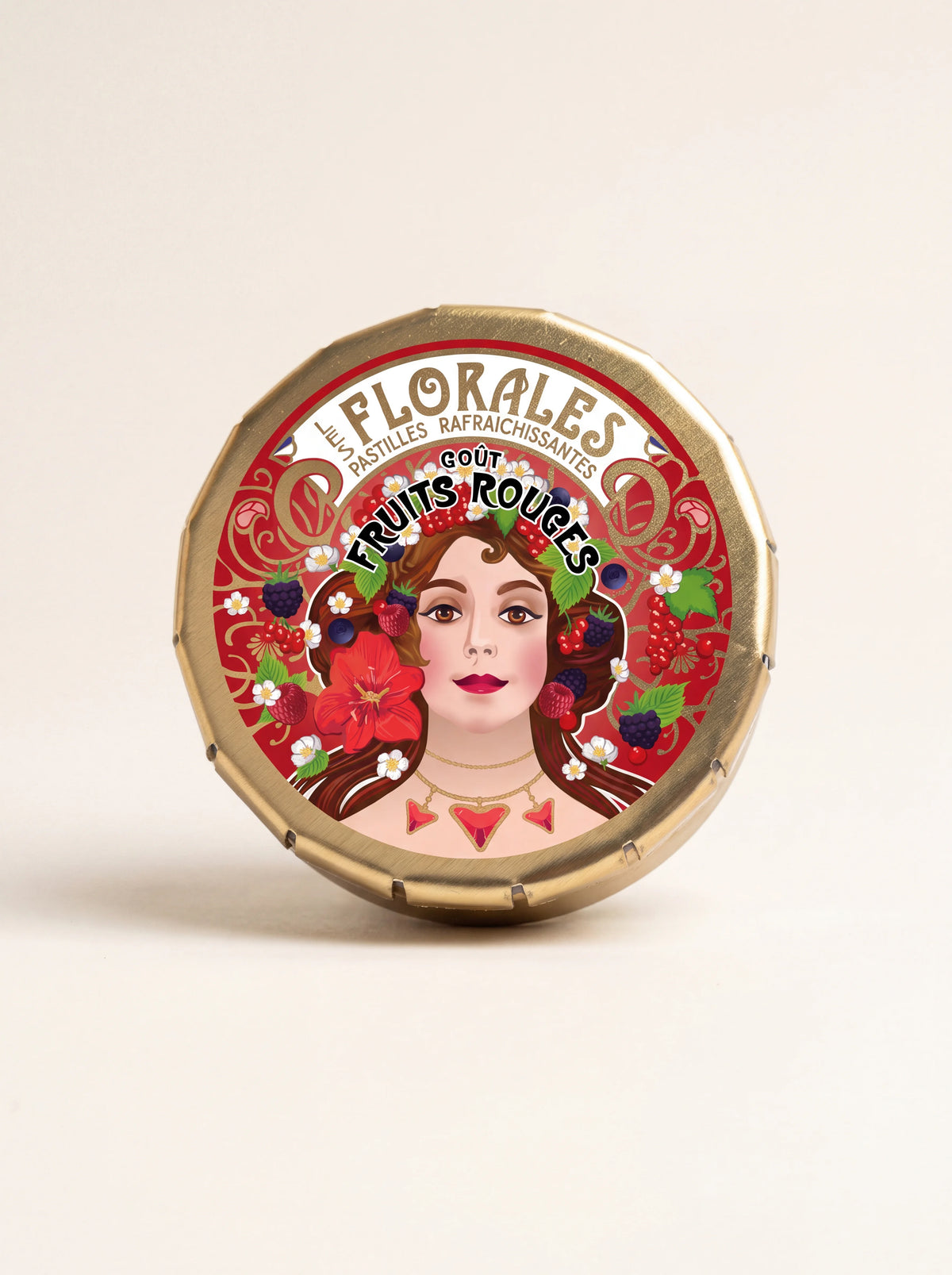 Round gold-tone metal tin for red fruit pastilles with an illustrated lid reading Les Florales Fruits Rouges